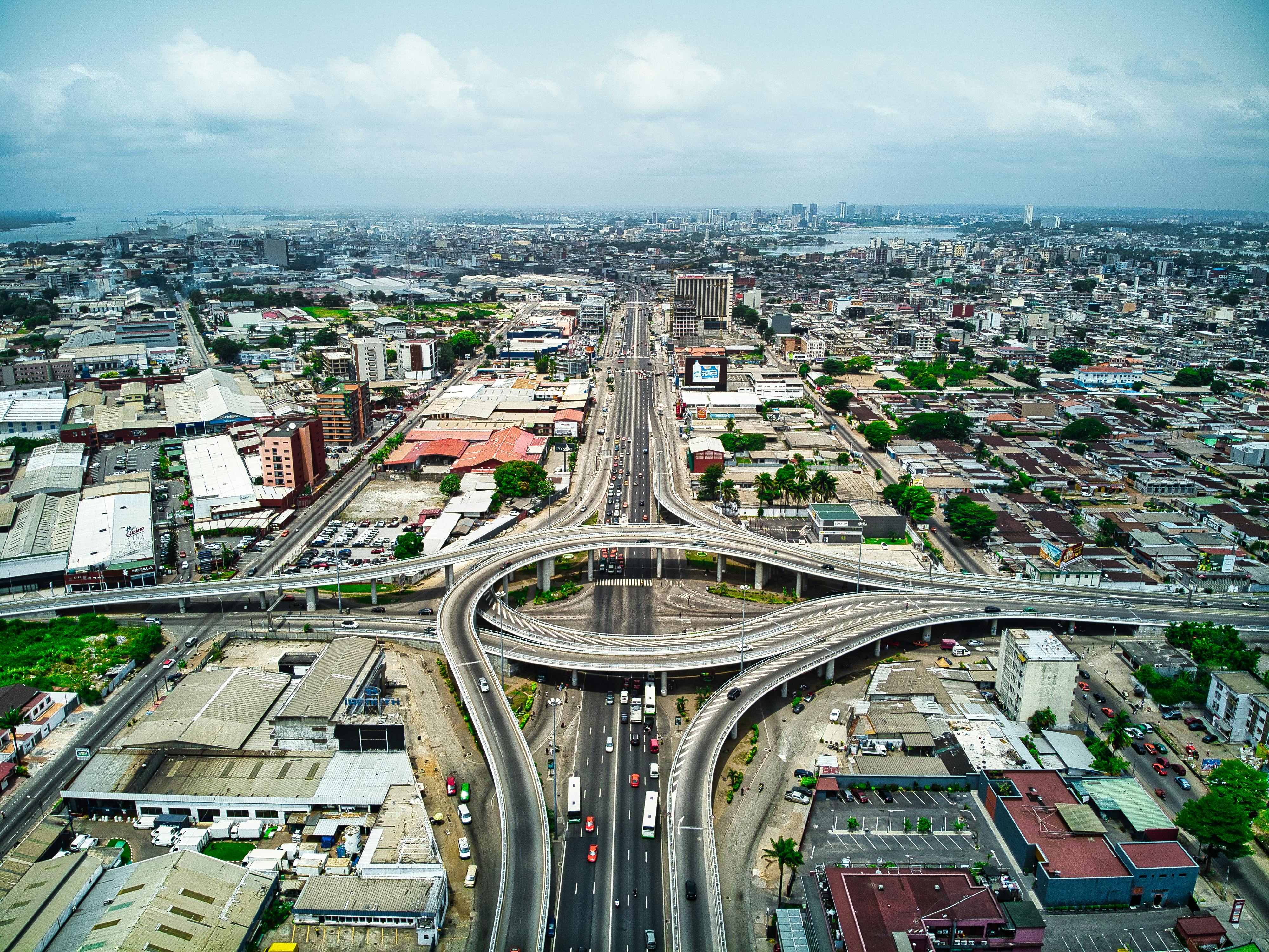 Aerial view of modern West African city with highway interchange and urban development